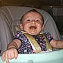 baby, high_chair, smiling, child, indoor, messy_face, clothing, seatbelt, kitchen, person, food_tray, happy, infant, cute, young_child, sitting, facial_expression, human, domestic, home