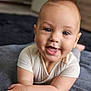 Sarah participe au concours pour gagner de l'argent avec cette photo : baby, smiling, happy, infant, child, cute, portrait, face, hands, lying_down, soft, indoors, closeup, young, skin, eyes, expression, toddler, apparel, blanket