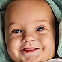 Sarah participe au concours pour gagner de l'argent avec cette photo : baby, smiling, face, close_up, blanket, child, cute, happy, infant, blue_eyes, soft_texture, portrait, clothing, young, human, skin, expression, cozy, warm, adorable