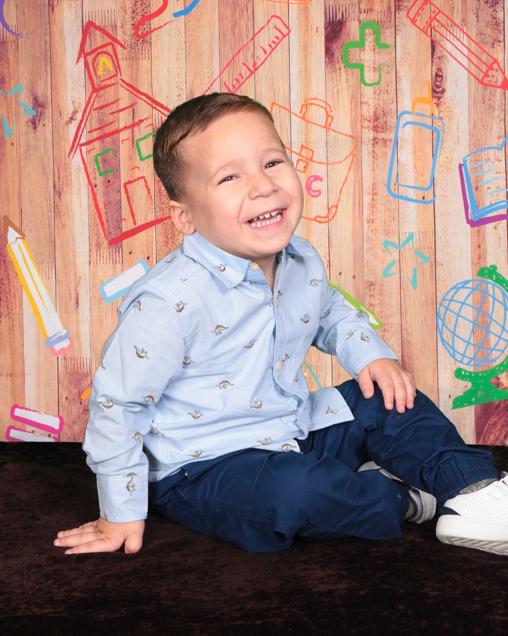 Julius is registered to the contest to win money with this photo: baby_toddler_clothing, cheek, child, dress_shirt, flooring, formal_wear, fun, happy, joy, laugh, leisure, pattern, person, play, portrait_photography, sitting, sleeve, smile, toddler, visual_arts