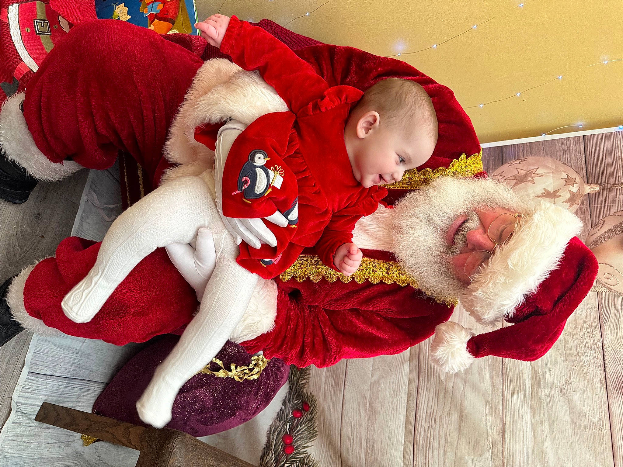 Eleri is registered to the contest to win money with this photo: baby, baby_toddler_clothing, carmine, christmas, christmas_eve, comfort, costume, event, fictional_character, fun, fur, happy, hat, headwear, holiday, lap, pattern, person, red, santa_claus
