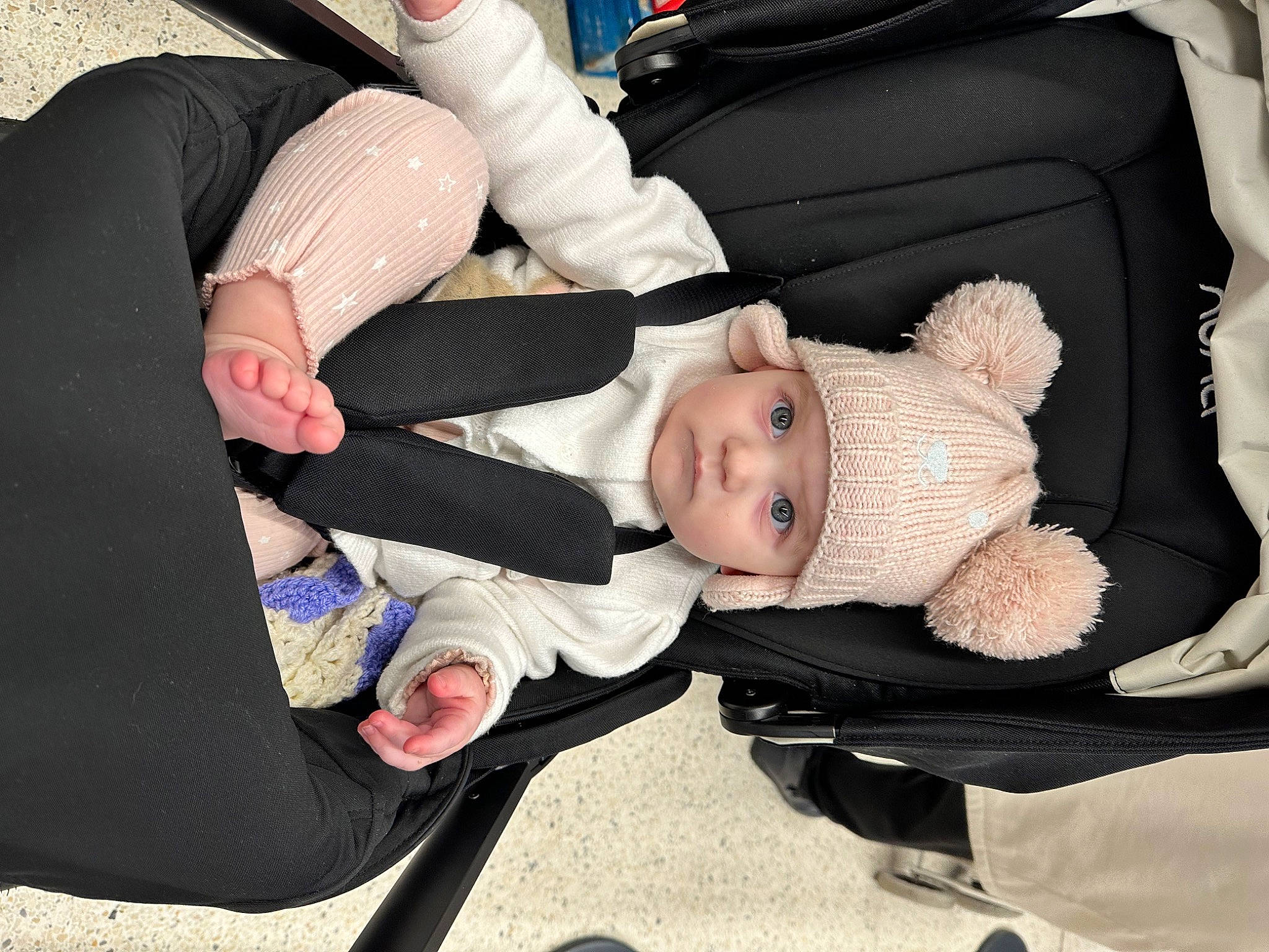 Eleri is registered to the contest to win money with this photo: baby, baby_carriage, baby_products, baby_toddler_clothing, car_seat, cheek, child, comfort, finger, fun, gesture, hand, happy, headwear, lap, person, product, sitting, smile, thumb