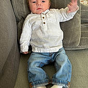 Mattéo a rejoint le concours — aidez-le/la à gagner de superbes lots ! baby, blanket, button_up, child, couch, cozy, denim, eyes_open, face, hand_gesture, indoor, infant, jeans, plush, portrait, socks, sofa, upholstery, white_shirt, wooden_chair_slats