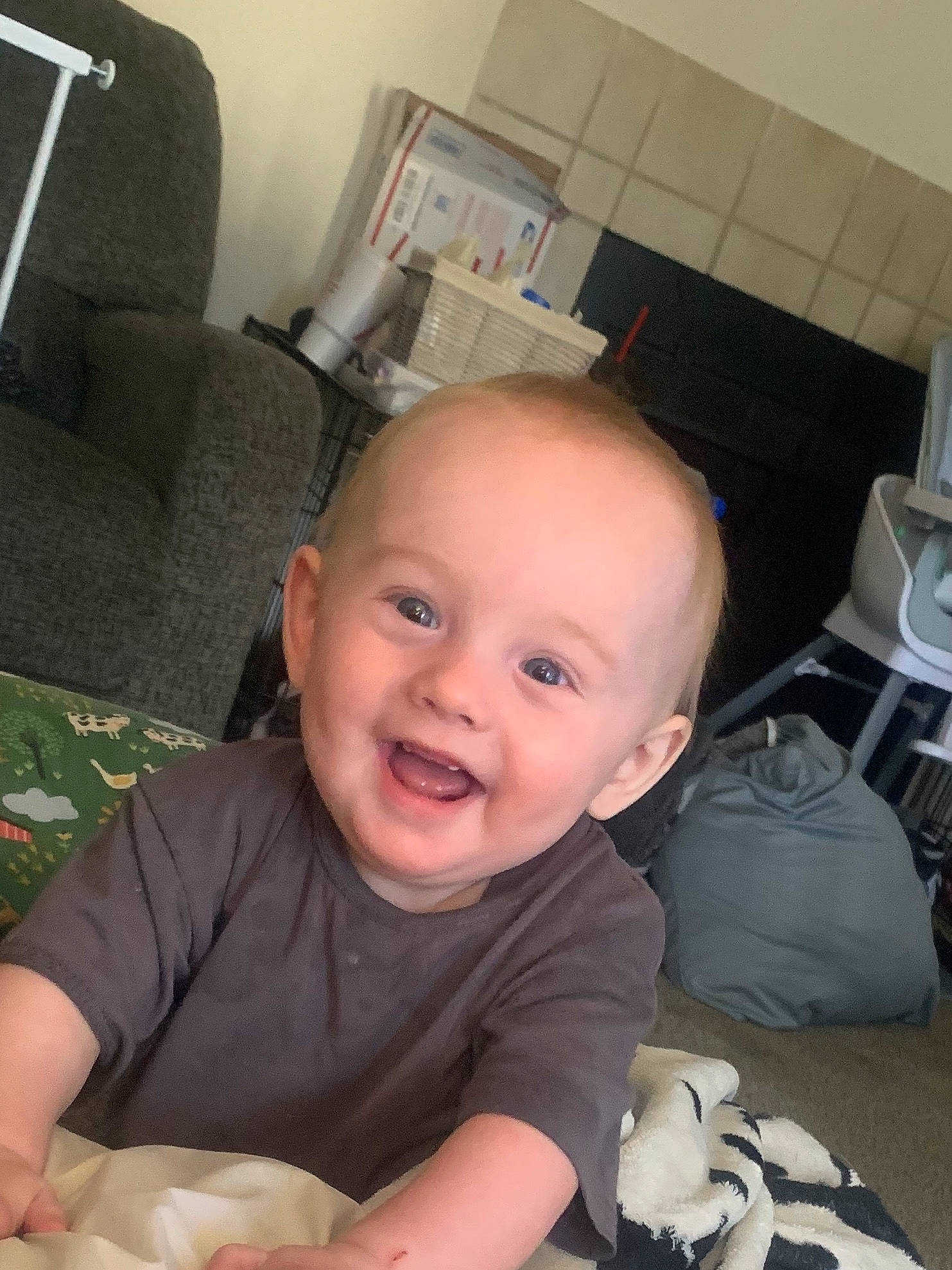 Jaxson joined the competition — help win amazing prizes! baby, baby_toddler_clothing, chair, cheek, child, comfort, face, finger, flooring, fun, happy, joy, mouth, nose, person, room, sitting, skin, smile, t_shirt