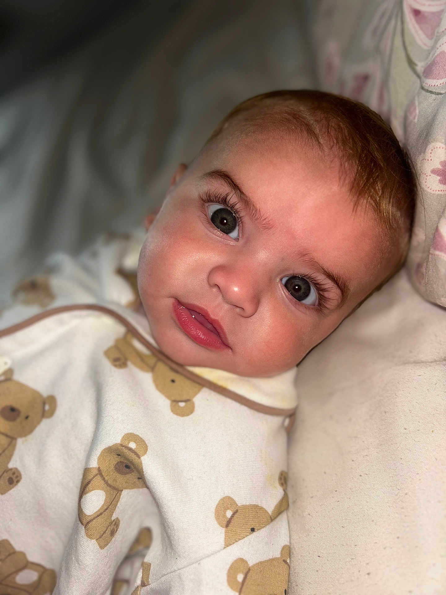 Cruz is registered to the contest to win money with this photo: baby, infant, face, eyes, blanket, teddy_bear_pattern, sleepwear, close_up, cute, child, soft_lighting, portrait, lying_down, eyelashes, expression, skin, head, cozy, indoor, pillow