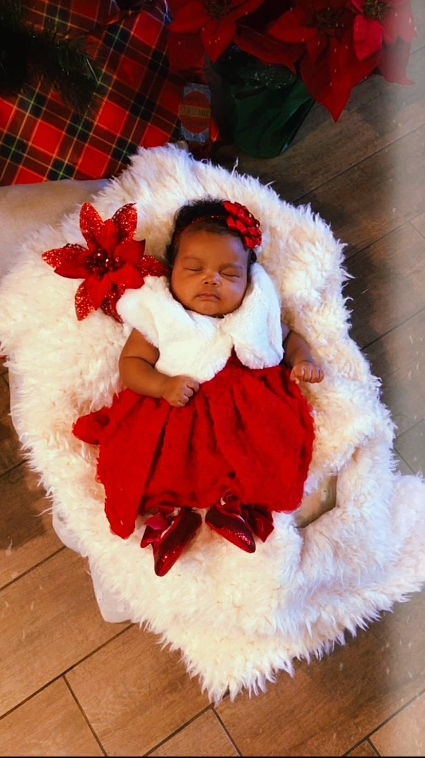 Royal is registered to the contest to win money with this photo: baby_toddler_clothing, child, christmas, costume, costume_hat, event, fashion_accessory, fur, fur_clothing, hair_accessory, happy, hat, human_body, person, petal, pink, red, sleeve, smile, toddler