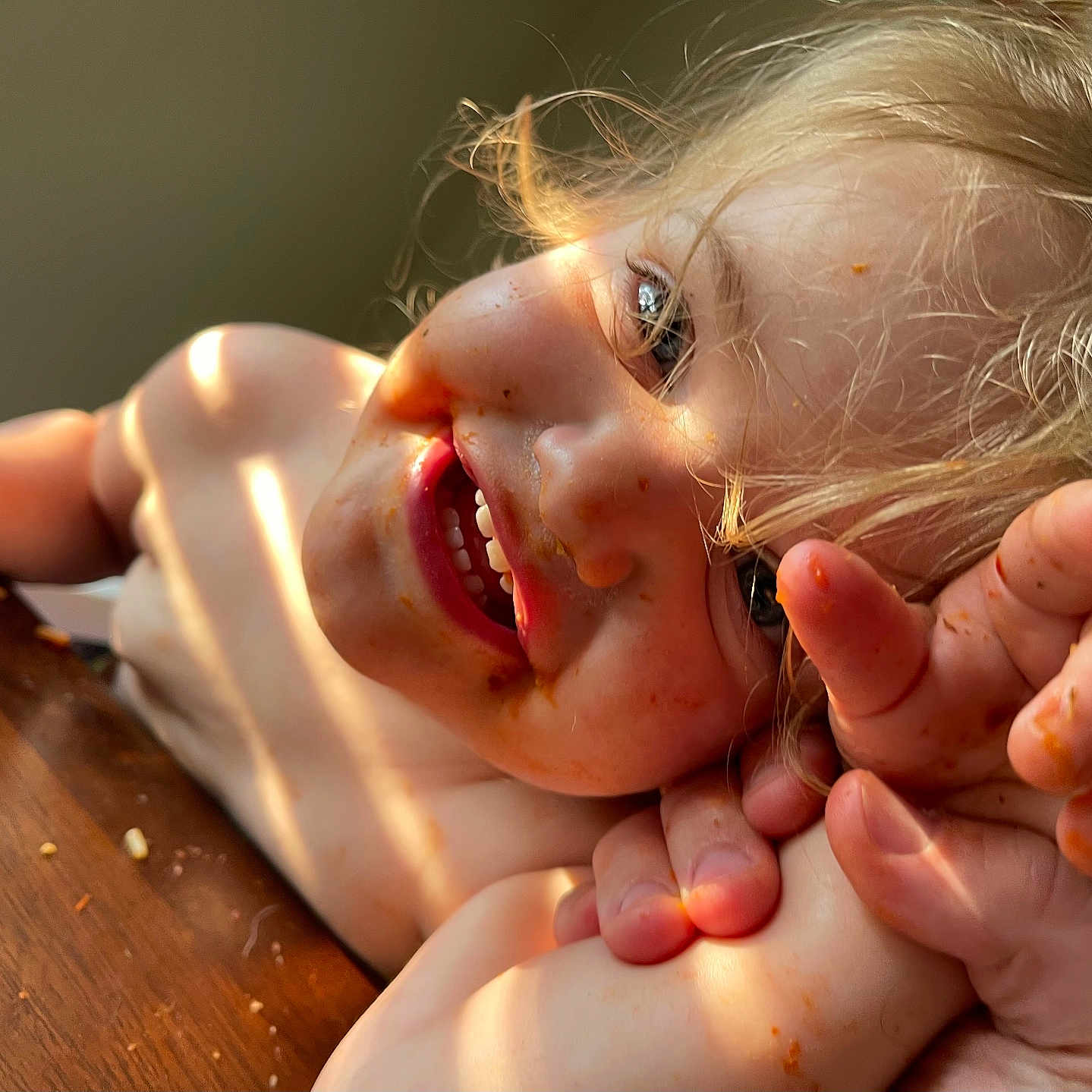 Riley is registered to the contest to win money with this photo: baby, babylaughing, bodypart, eating, face, finger, food, hand, happy, hardwood, head, laughing, mouth, nail, person, photography, portrait, smile, teeth, wood