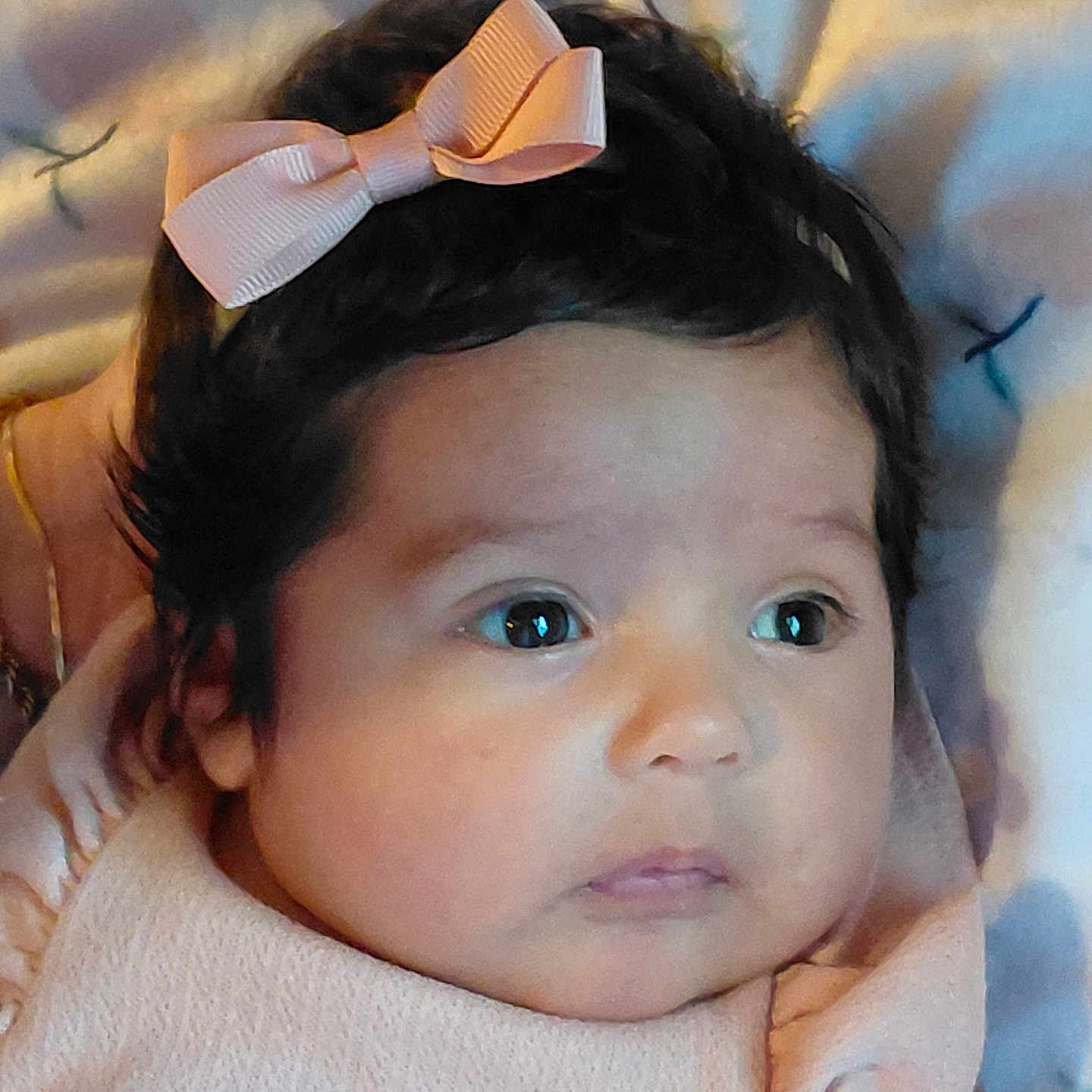 Ella'Cee is registered to the contest to win money with this photo: adorable, baby, big_eyes, blanket, child, closeup, clothing, cute, dark_hair, expression, face, head, infant, lying_down, newborn, peaceful, pink_bow, portrait, skin, soft_texture