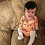 Wrenleigh is registered to the contest to win money with this photo: baby, child, infant, couch, brown_couch, orange_clothing, halloween_outfit, ghost_pattern, black_bow, headband, white_socks, knee_high_socks, smiling, sitting, indoor, cute, happy, person, plush_furniture, portrait