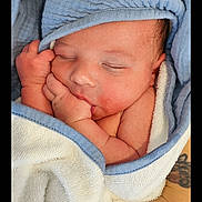 Gabriel participe au concours pour gagner de l'argent avec cette photo : newborn, baby, sleeping, towel, blue_trim, hand, tattoo, skin, face, wrapped, peaceful, infant, closeup, human, person, soft_texture, resting, gentle, cute, wrapped_in_towel
