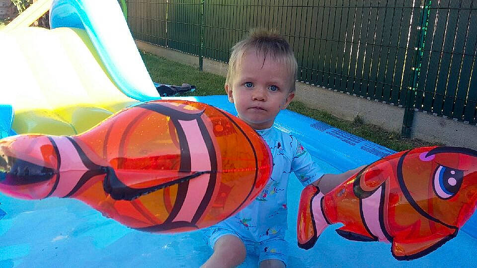 Ethan a rejoint le concours — aidez-le/la à gagner de superbes lots ! art, baby, baby_products, baby_toddler_clothing, child, eyewear, fun, games, goggles, grass, human_settlement, inflatable, leisure, orange, outdoor_play_equipment, person, personal_protective_equipment, play, playground, recreation