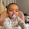 Layana a rejoint le concours — aidez-le/la à gagner de superbes lots ! baby, banister, child, cute, face, feeding_chair, hands, highchair, home_interior, indoor, long_sleeves, pacifier, patterned_shirt, pink_pacifier, portrait, smile, staircase, table, toddler, young_child