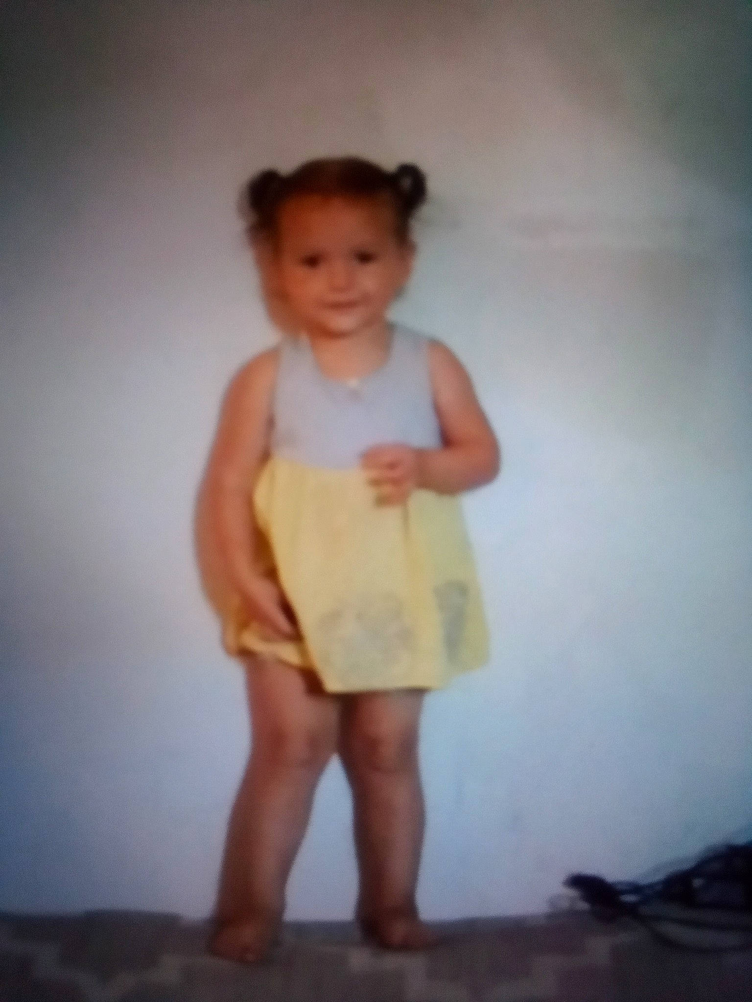 Isabella is registered to the contest to win money with this photo: barefoot, day_dress, elbow, flash_photography, foot, fun, gesture, happy, human_leg, joy, knee, one_piece_garment, person, room, shoulder, sleeve, smile, toddler, trunk, vintage_clothing