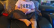 Xaviona joined the competition — help win amazing prizes! child, toddler, smiling, sitting, portrait, indoors, leather_chair, recliner, leopard_print, pillows, paris_shirt, pink_shirt, skirt, barefoot, toy, living_room, home, furniture, wall_clock, happy