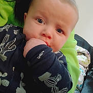 Karson joined the competition — help win amazing prizes! baby, child, blue_eyes, hand, cactus_print, dark_blue_clothing, blanket, green_blanket, indoor, close_up, cute, infant, face, resting, dog, animal, sleeping_dog, soft_light, portrait, young_child