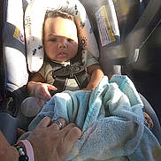 Lyric is registered to the contest to win money with this photo: baby, car_seat, child, seatbelt, hand, towel, sunlight, shadow, interior, car, person, ring, bracelet, protection, infant, clothing, seat, safety, comfort, human