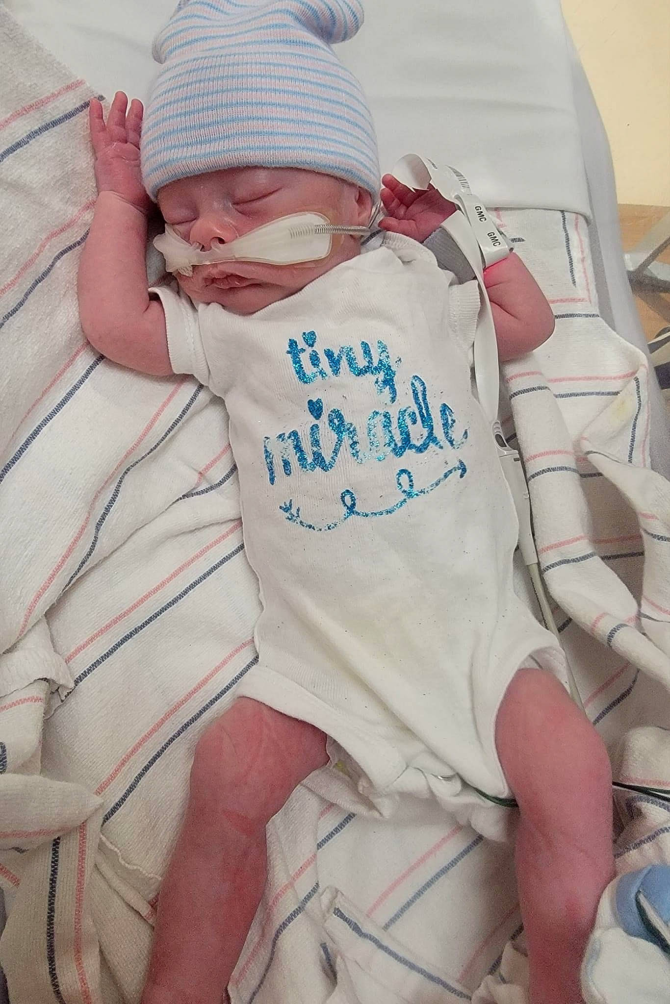 Kaden joined the competition — help win amazing prizes! baby, baby_products, baby_sleeping, baby_toddler_clothing, cap, child, comfort, elbow, glasses, hospital, hospital_bed, human_body, human_leg, knee, linens, person, room, sitting, sleeve, thigh