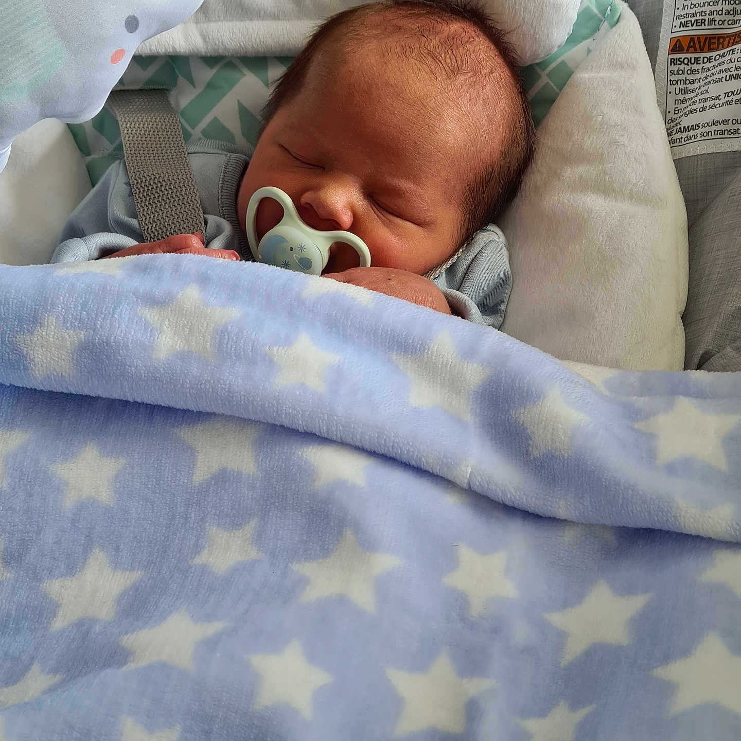 Finn is registered to the contest to win money with this photo: architecture, baby, bed, blanket, building, cradle, crib, cushion, face, furniture, head, homedecor, hospital, infantbed, newborn, person, photography, portrait, quilt, sleeping