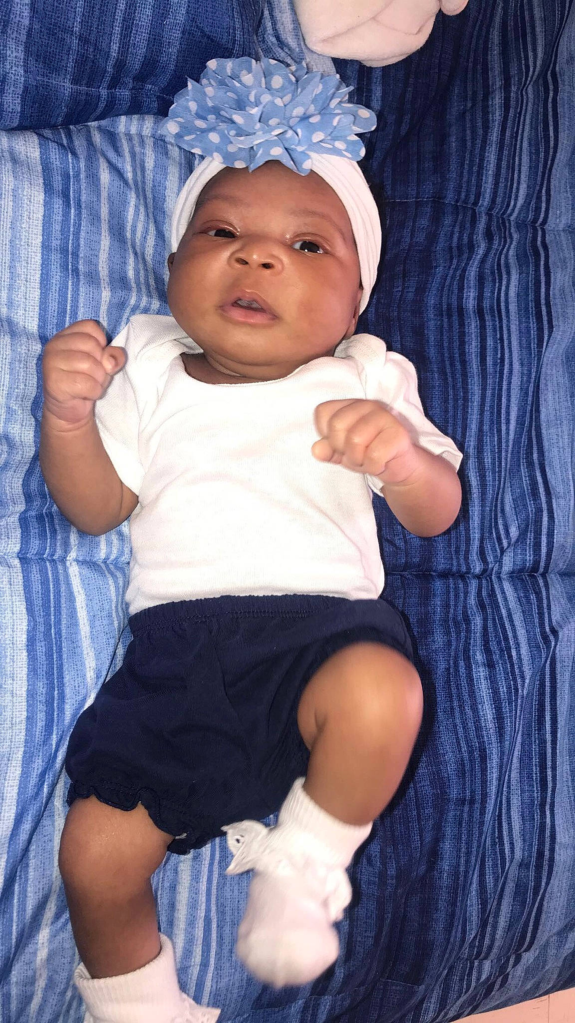 Janai joined the competition — help win amazing prizes! arm, baby, baby_products, baby_toddler_clothing, blue, bonnet, cheek, child, eye, happy, head, headgear, people, person, product, skin, smile, toddler, white