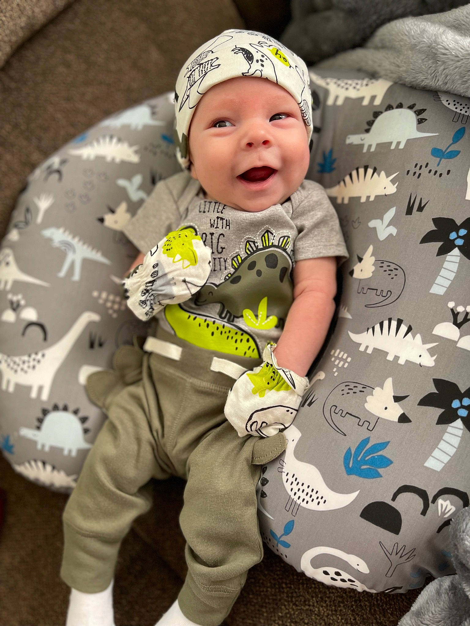 Cashton is registered to the contest to win money with this photo: baby, baby_toddler_clothing, beanie, cap, child, cool, facial_expression, fun, grass, happy, hat, headwear, logo, pattern, person, personal_protective_equipment, portrait_photography, sitting, sleeve, smile