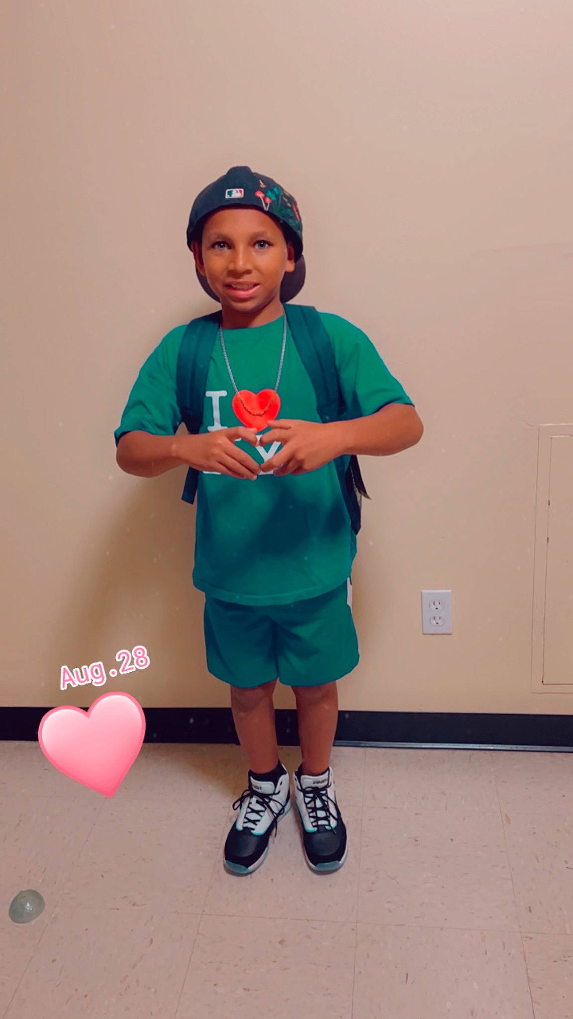 Kevin is registered to the contest to win money with this photo: baseball_cap, cap, child, electric_blue, event, fun, happy, headwear, joint, joy, knee, leisure, magenta, person, recreation, room, shorts, shoulder, sleeve, sneakers