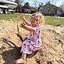 child, toddler, sand, playing, curly_hair, dress, barefoot, outdoor, sunny, boat, trailer, house, yard, grass, portrait, smile, hands, sand_throwing, fun, daytime