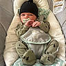 Kasen joined the competition — help win amazing prizes! baby, infant, child, portrait, bouncer, baby_seat, pacifier, black_hat, hat, green_outfit, onesie, blanket, cushion, sitting, indoors, furniture, textile, woodland_pattern, face, cozy