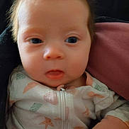Zoey joined the competition — help win amazing prizes! baby, infant, face, onesie, clothing, starfish_pattern, closeup, portrait, cute, child, young, sleepwear, pink, dark_background, expression, newborn, soft, person, indoors, human