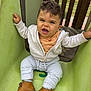 toddler, child, slide, playground, shoes, jacket, pants, outdoor, smiling, face, hands, wood, green, casual_clothing, fun, baby, park, person, happy, daytime