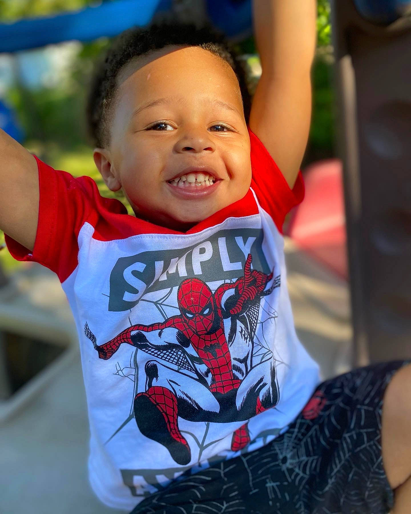 Jonathan is registered to the contest to win money with this photo: baby, baby_toddler_clothing, carmine, child, cool, fun, gesture, happy, head, human_body, leisure, lip, neck, person, recreation, sitting, sleeve, smile, t_shirt, toddler