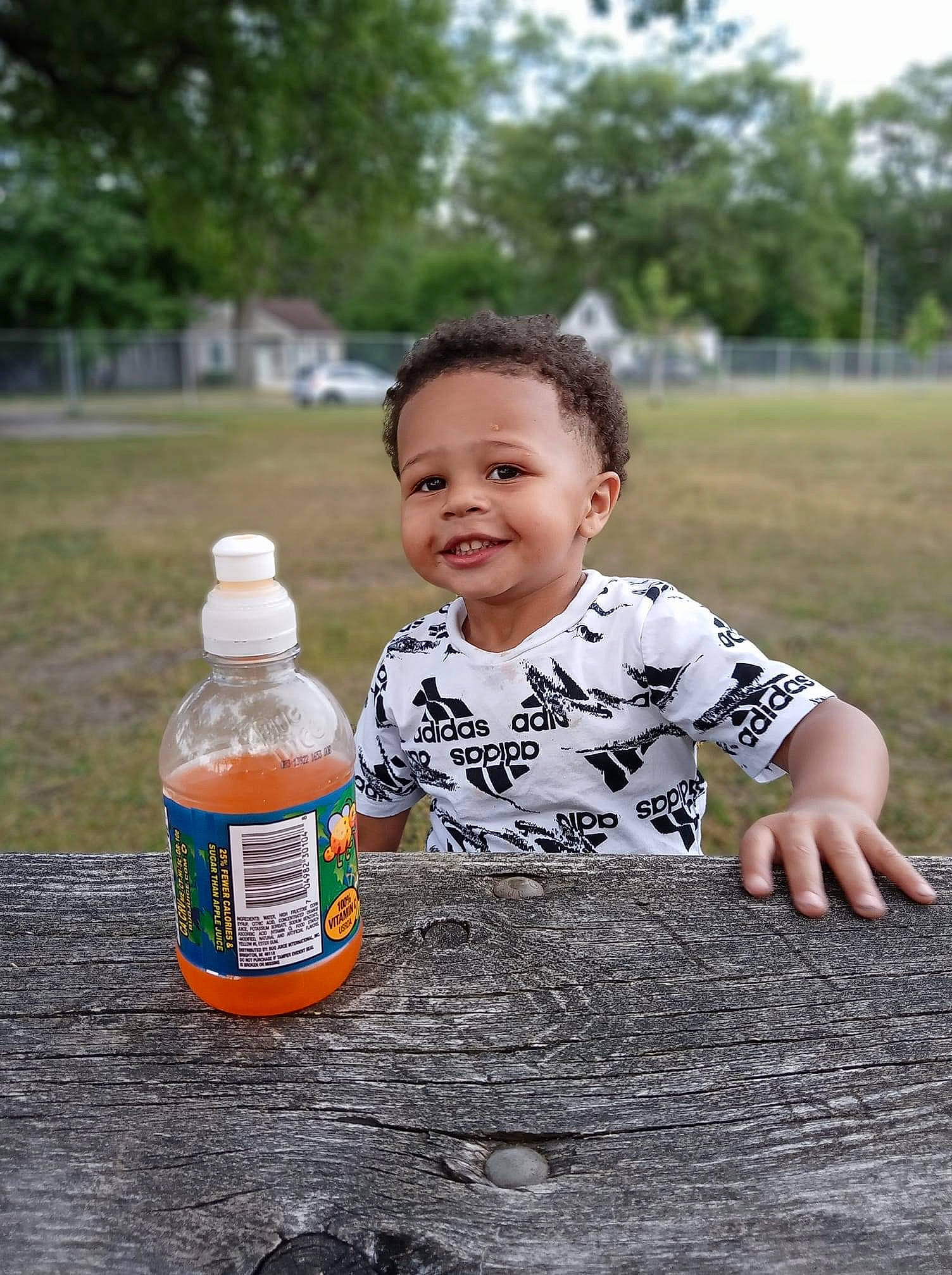 Jonathan joined the competition — help win amazing prizes! baby_toddler_clothing, bottle, bottle_cap, child, drink, drinkware, gas, glass_bottle, grass, happy, joy, person, plant, plastic_bottle, recreation, smile, soil, t_shirt, toddler, tree