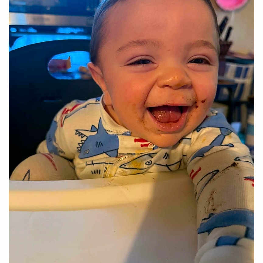 Maxamus joined the competition — help win amazing prizes! baby, smiling, high_chair, food, messy_face, indoor, kitchen, microwave, child, cute, happy, clothing, person, infant, seat, home, expression, young_child, face, joy