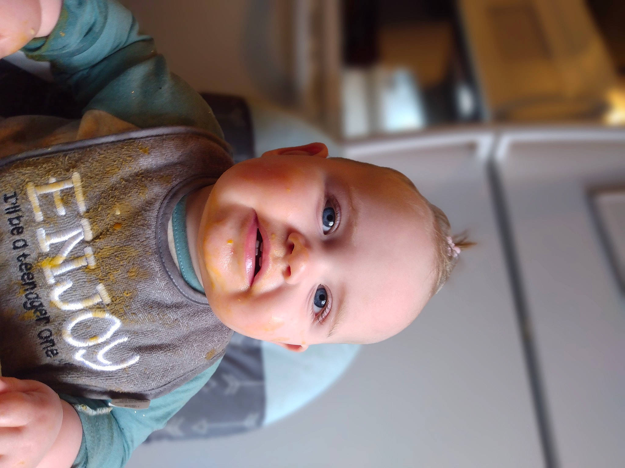 Astrid is registered to the contest to win money with this photo: baby, cheek, child, chin, dress, eyebrow, eyelash, finger, gesture, hand, happy, hat, lip, mouth, nose, person, skin, sleeve, smile, toddler