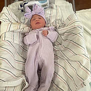 Adalynn is registered to the contest to win money with this photo: baby, newborn, infant, bassinet, hospital_bassinet, blanket, striped_blanket, onesie, bow_hat, swaddle, sleeping, portrait, pink, footed_pajamas, medical_device, crib, cute, newborn_room, fabric, laying_down