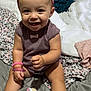 baby, child, smiling, headband, bracelets, purple_clothing, pink_socks, baby_brush, bed, blanket, happy, indoors, person, cute, infant, sitting, toy, accessories, skin, face