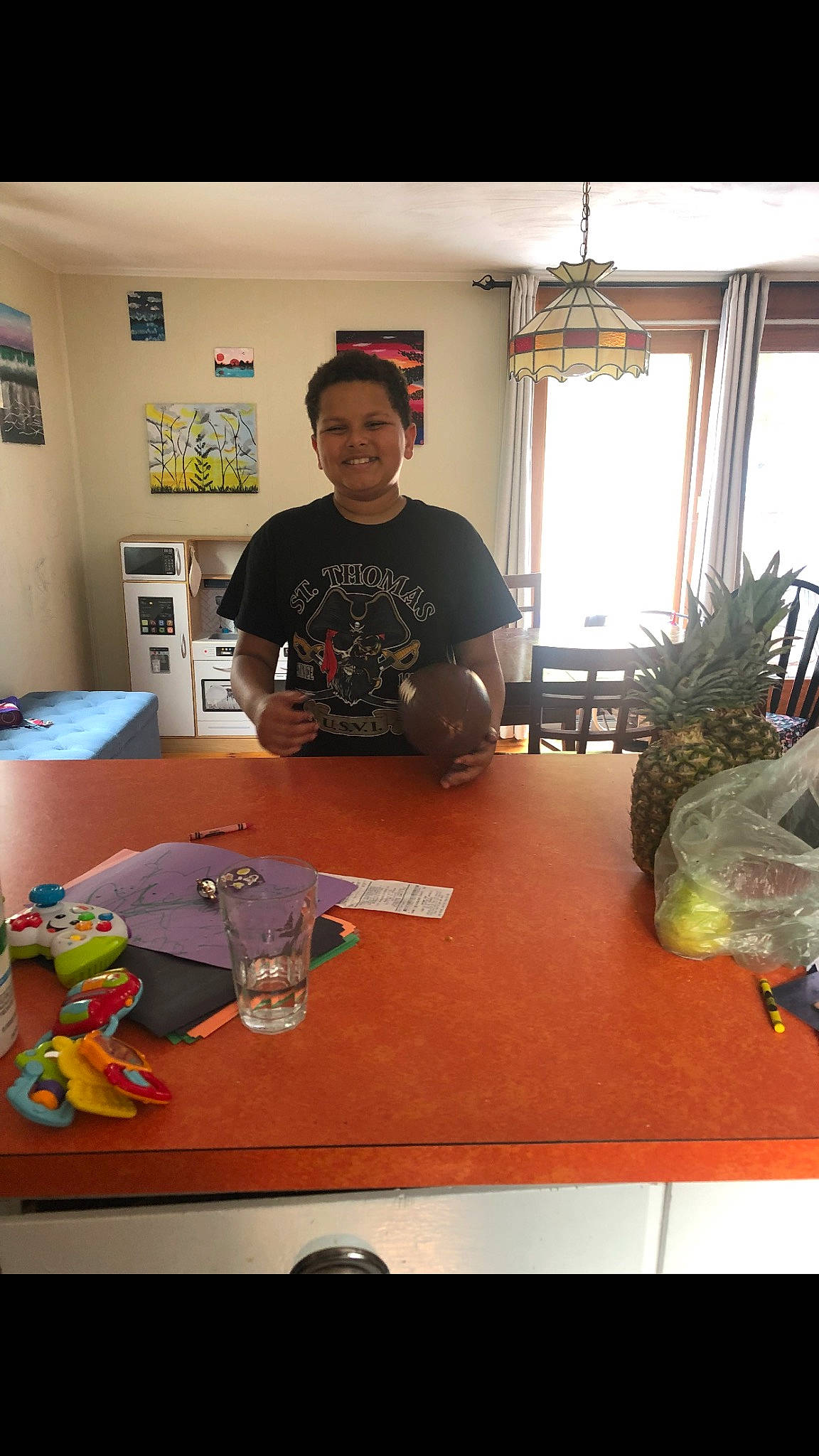 Liam is registered to the contest to win money with this photo: art, artist, curtain, desk, engineering, event, flooring, fun, joy, machine, person, plant, recreation, room, smile, t_shirt, table, textile, toy, visual_arts