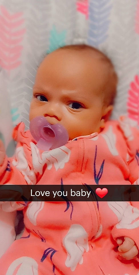 Destiny is registered to the contest to win money with this photo: baby, baby_toddler_clothing, cheek, child, chin, comfort, facial_expression, fun, happy, linens, magenta, mouth, nose, orange, peach, person, pink, skin, smile, textile