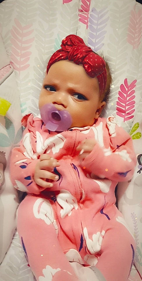 Destiny is registered to the contest to win money with this photo: baby, baby_products, baby_toddler_clothing, cheek, child, comfort, event, face, facial_expression, fun, gesture, happy, lip, mouth, peach, person, pink, room, skin, thumb