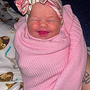 Ashlynn joined the competition — help win amazing prizes! baby, newborn, smiling, pink_blanket, headband, flower, wrapped, cozy, sleepy, infant, cute, knitted, soft, happy, child, portrait, closeup, skin, face, resting