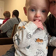 Odin joined the competition — help win amazing prizes! baby, child, adult, indoor, family, pajamas, dinosaur_print, lap, hand, fingers, blue_eyes, curious, seated, sweater, laptop, back_view, brown_hair, watch, woman, cozy
