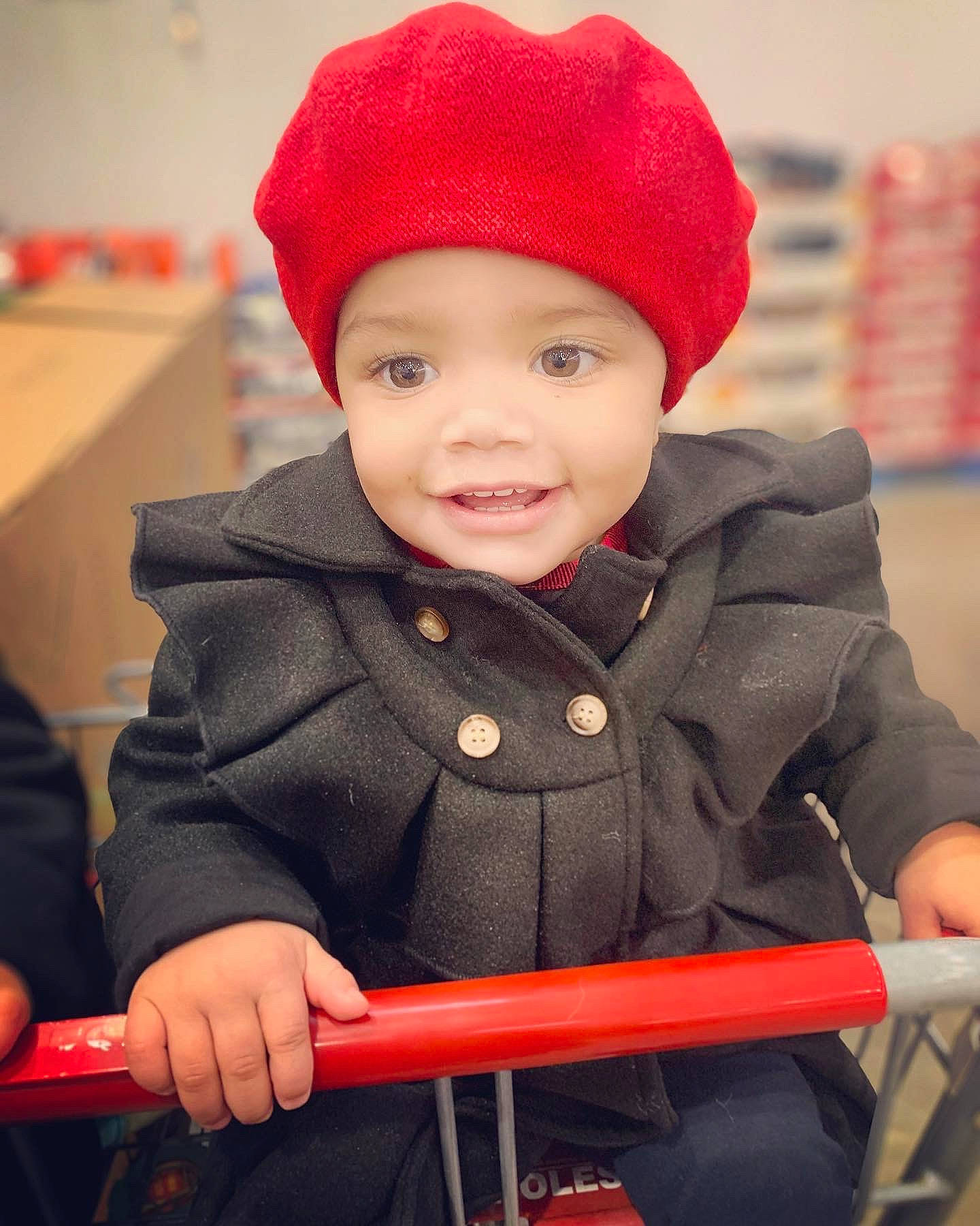 Mylah is registered to the contest to win money with this photo: baby, baby_toddler_clothing, cap, child, clothing, facial_expression, fun, happy, headgear, headwear, jacket, joy, knit_cap, organ, outerwear, person, photograph, red, sleeve, smile