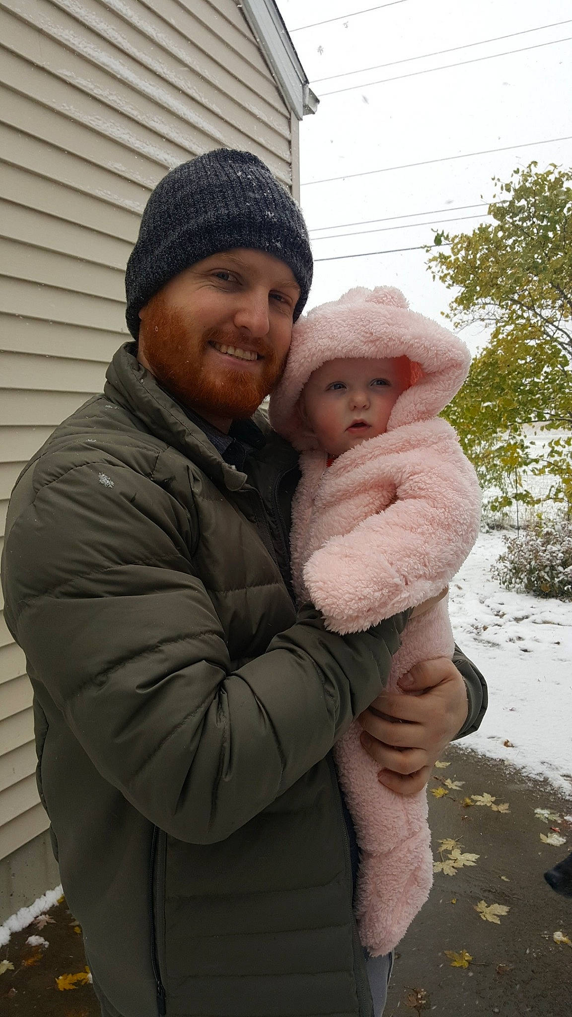 Kirra is registered to the contest to win money with this photo: child, daughter, father, headwear, hug, joy, person, snow, toddler