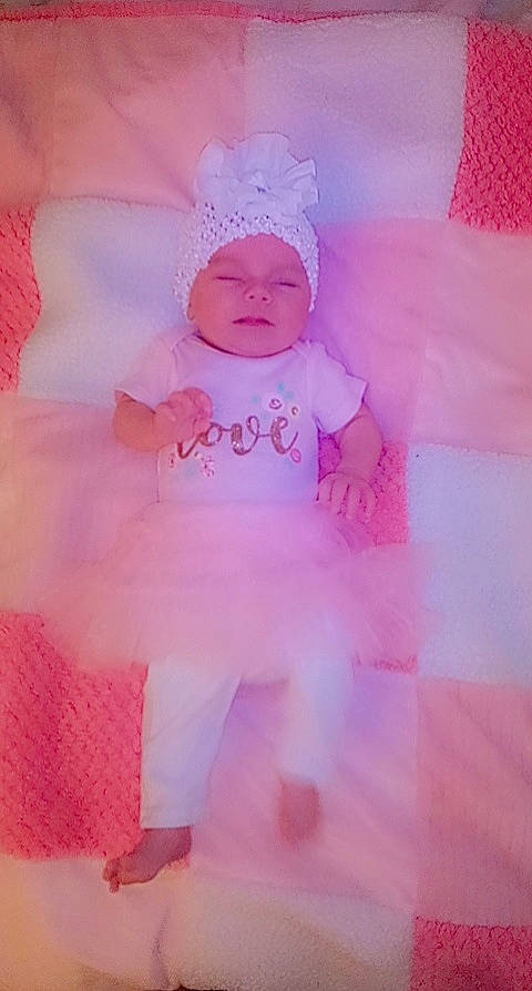 Kenlee joined the competition — help win amazing prizes! baby, baby_products, baby_toddler_clothing, child, dress, embellishment, face, fashion_accessory, hair_accessory, happy, headgear, headwear, magenta, pattern, peach, person, petal, pink, purple, sleeve