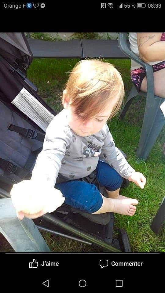 Louanne participe au concours pour gagner de l'argent avec cette photo : automotive_wheel_system, baby, baby_carriage, baby_products, chair, child, denim, electric_blue, fun, grass, lap, leisure, person, plant, play, recreation, shoe, sitting, sneakers, toddler