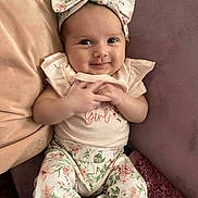 Amira Rose joined the competition — help win amazing prizes! baby, infant, girl, smiling, headband, bow, floral, pants, couch, pillow, pink, pastel, cute, child, clothing, portrait, happy, indoors, soft, comfort