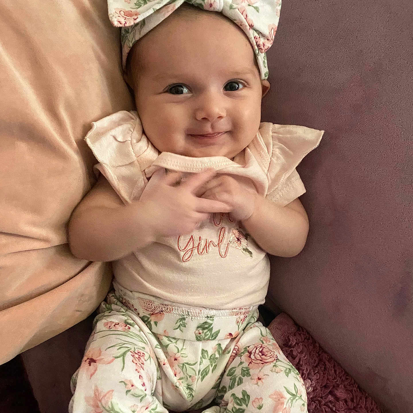 Amira Rose joined the competition — help win amazing prizes! baby, bow, child, clothing, comfort, couch, cute, floral, girl, happy, headband, indoors, infant, pants, pastel, pillow, pink, portrait, smiling, soft