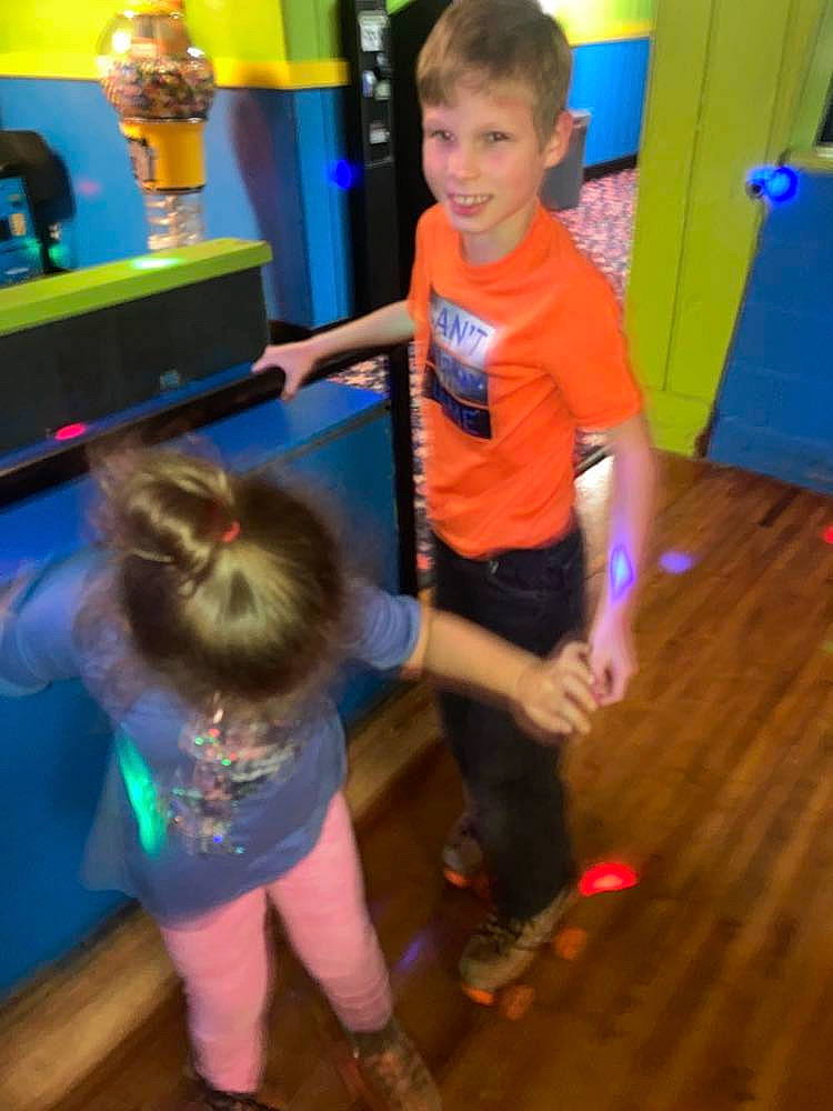 Skyler is registered to the contest to win money with this photo: blue, child, door, electric_blue, entertainment, event, flooring, fun, green, happy, joy, leisure, party, person, play, sandal, shorts, smile, standing, t_shirt