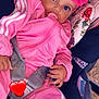 baby, infant, pink_clothing, headband, flower, pacifier, car_seat, seatbelt, child, wide_eyes, hand, floral_pattern, pink_jacket, pink_pants, cute, portrait, outdoor, comfort, safety, love_emoji