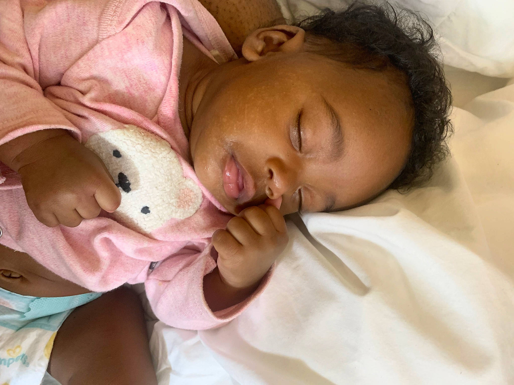 Micah is registered to the contest to win money with this photo: baby, baby_products, bed, bedtime, cheek, child, comfort, ear, eyelash, finger, hand, happy, human_body, linens, lip, mouth, nose, person, skin, textile