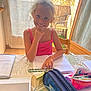 Shelby participe au concours pour gagner de l'argent avec cette photo : child, girl, glasses, smile, pink_tank_top, study, table, stationery, ruler, pencil_case, notebook, glass_of_water, indoor, window, door, balcony, chair, wood_floor, natural_light, happy